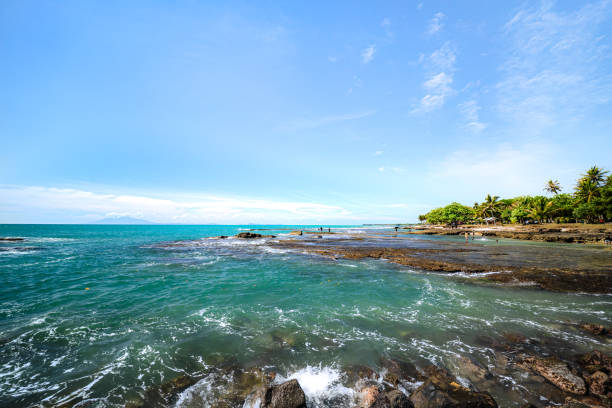 istock Tranquil Coastal Scene with Soft Water Effect. Bright Blue Sea Reflecting the Sunshine. 2187130148