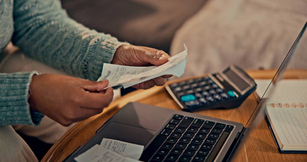 istock Close up woman holding receipt, using laptop 2187135221