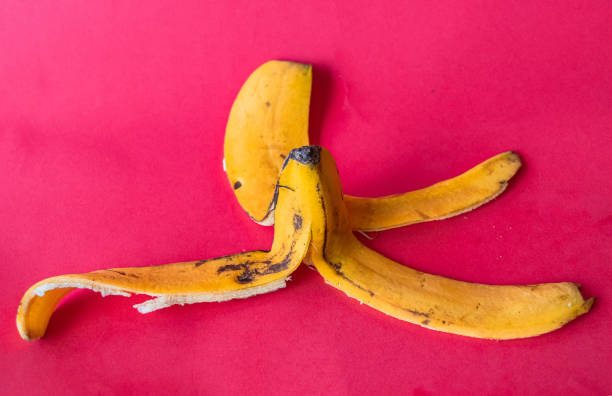 Ripe banana, opened to reveal its creamy pulp, rests on a vibrant yellow background, showcasing a striking contrast of color and texture that highlights its tropical appeal