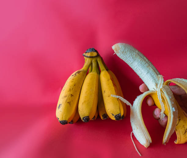 istock Bananas and plantains on a red background 2187136886