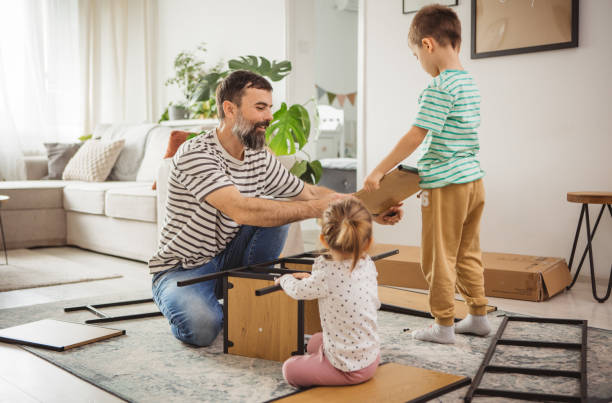 istock Happy father and kids assembling furniture 2187137018