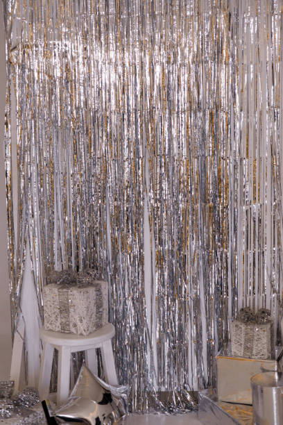 istock Glittering Party Backdrop with Silver Streamers and Decorative Presents 2187137222