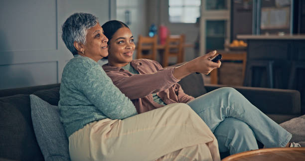 istock Mother and daughter watching tv. 2187137567
