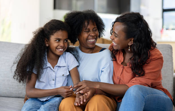 istock Three generation of women smiling at home 2187141883