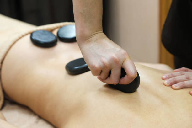 istock A Relaxing Back Massage with Heated Basalt Stones, Providing Deep Muscle Relief and Soothing Warmth to Enhance the Overall Spa Experience, Promoting Stress Reduction 2187142136