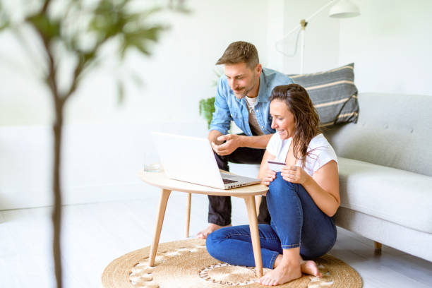 istock bearded husband cuddling affectionate wife on computer at home. Using laptop in living room. 2187142760