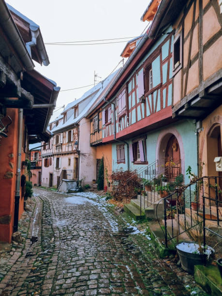 istock Eguisheim with Christmas decoration - Charming, colorful, snowy cobblestone street with half-timbered houses in snow and colorful facades, France's most beautiful village, Alsace region, France 2187143473