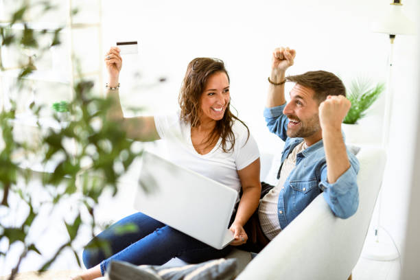 istock bearded husband cuddling affectionate wife on computer at home. Using laptop in living room. 2187144703