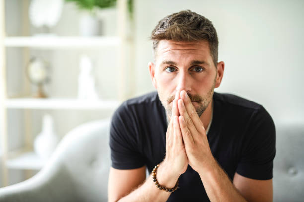 istock Sad bearded man in casual sitting on couch at home 2187145726