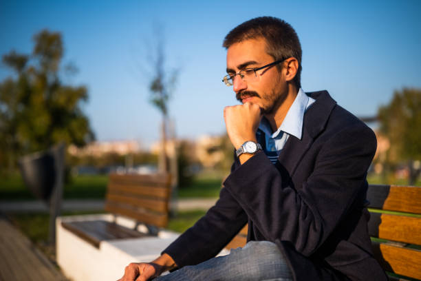 istock Sad businessman sitting outdoor 2187147102