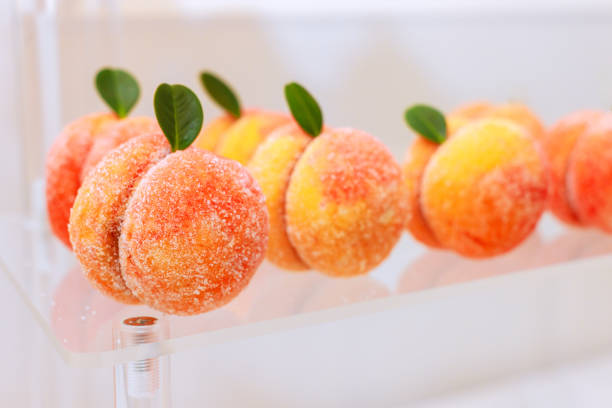 istock Peach shaped pastries lined on display at bakery during festive occasion 2187150167