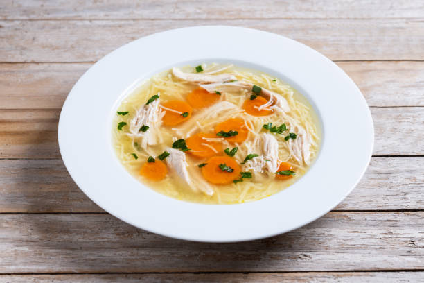 istock Homemade chicken soup on wooden table 2187152046