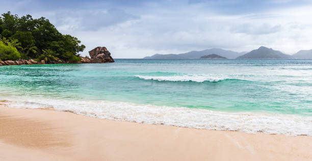 istock Panoramic La Digue beach view with mountains of Praslin island 2187152205
