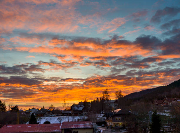 Landscape with mountains in backlight and the sky with warm colors of the sunset in Roana in Italy