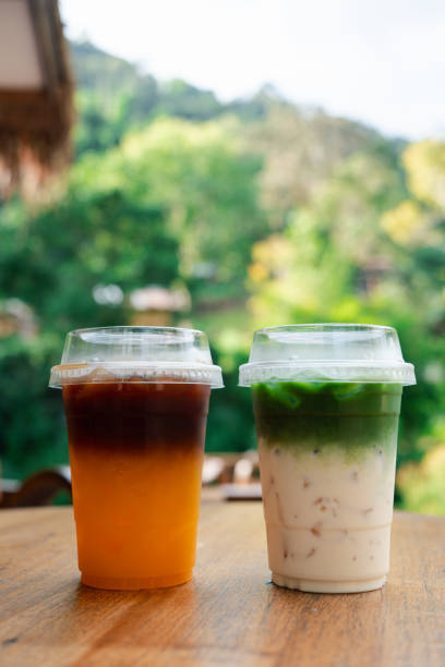 istock Black coffee separate layer with orange juice and green tea separate layer with fresh milk. 2187158242