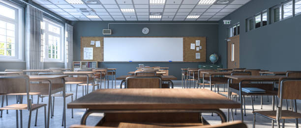 istock Sunlight streams into an empty classroom, illuminating rows of wooden desks and a blank whiteboard, ready for a new school day 2187158317