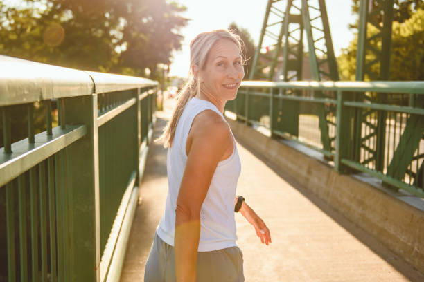 istock great sporty woman jogging outdoors on sunset time 2187160672