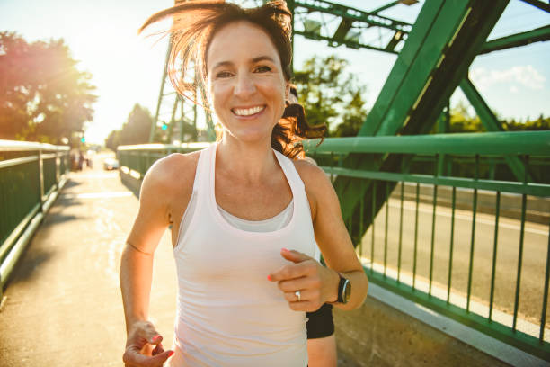 istock great sporty woman jogging outdoors on sunset time 2187160682