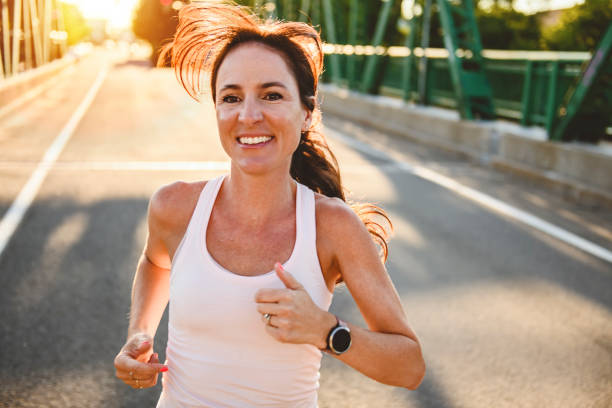 istock great sporty woman jogging outdoors on sunset time 2187160715