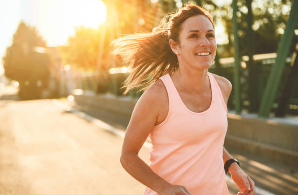 istock great sporty woman jogging outdoors on sunset time 2187160718