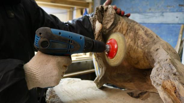 istock A worker processes a piece of wood with a handheld sander 2187163277