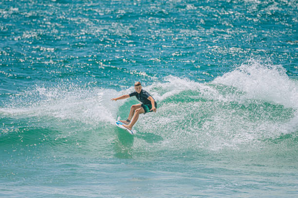 young Australian boy surfing in gold coast
