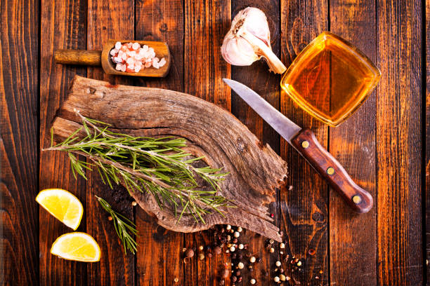 istock Rosemary sprig on a wooden kitchen table. 2187163923