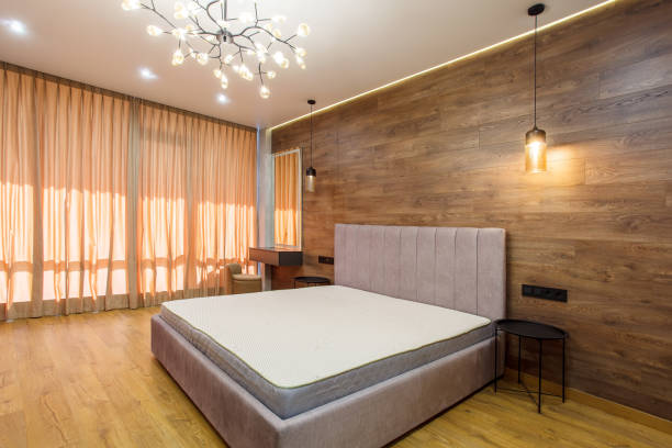 istock large modern bedroom bed with headboard warm wooden laminate on wall 2187166502