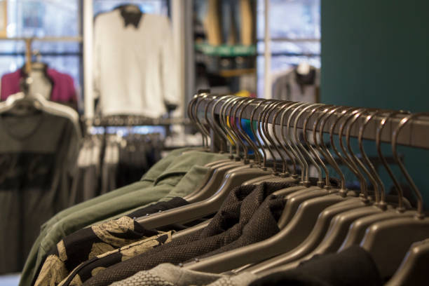 istock Man multi color shirts on hangers in shopping mall 2187169179