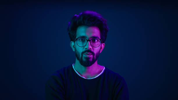 istock Male portrait neon background shocked amazed astonish wonder Indian man coder hacker computer technology worker guy looking in front futuristic high-tech software hologram mock up infographic backdrop 2187170213