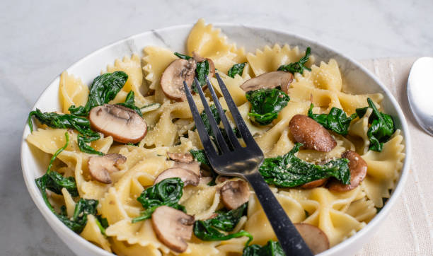 istock farfalle pasta  with spinach and mushrooms 2187171998