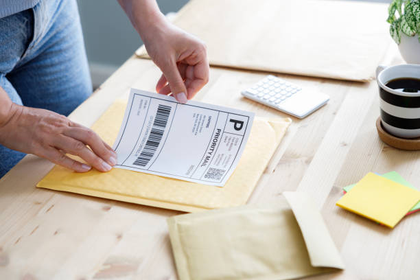 istock Young entrepreneur packs customer's orders 2187173400