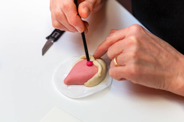 istock Baker is decorating a fancy bread shaped like a heart 2187173617