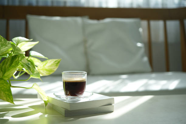 istock Coffee glass cup on white table philodendron plant interior view, minimal home 2187174168