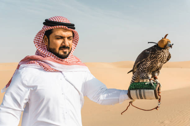 istock arab man with falcon in the desert 2187175185