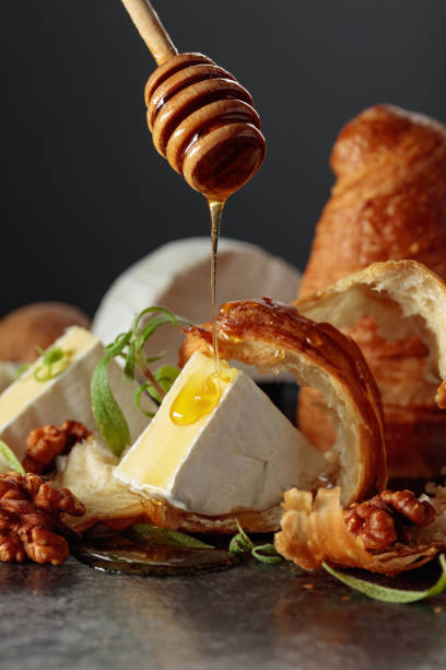 istock Camembert cream cheese with honey, croissants, and walnuts. 2187175222