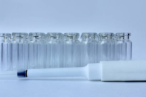 New glass vials for instrumental analysis on a white background. analytical vials prepared for chemical analysis.