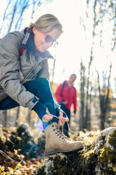 istock Woman tying shoelace on her hiking boot 2187175348