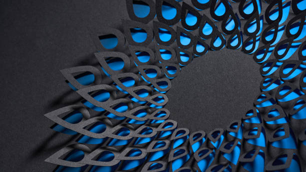 istock Striking black cut-paper mandala artwork with layered petal designs, illuminated by vivid blue backlighting. 2187176401