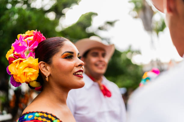 Young chiapaneca (traditional mexican dancer) talking to friends outdoors