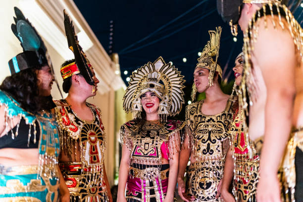 Young friends talking in aztec clothes outdoors
