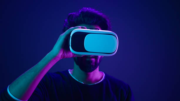 istock Metaverse virtual reality cyberspace amazed wonder man take off VR goggles helmet after play game meta universe experience digital technology excited cyber gamer at neon ultraviolet futuristic space 2187177693