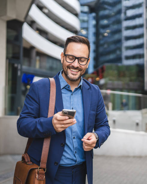 istock businessman walk around city and use mobile phone 2187178500