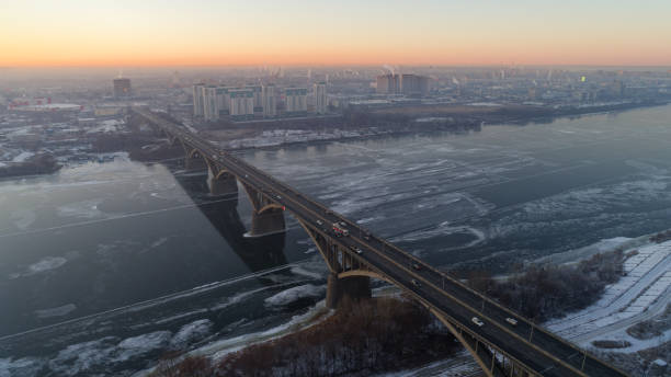 istock Bridge spans a river with a city in the background 2187180465