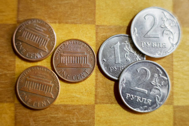 istock One-cent coins lie opposite one-ruble coins on a chessboard, macro shot, devaluation of the ruble, decline of the Russian economy, inflation of the Russian currency. 2187182685