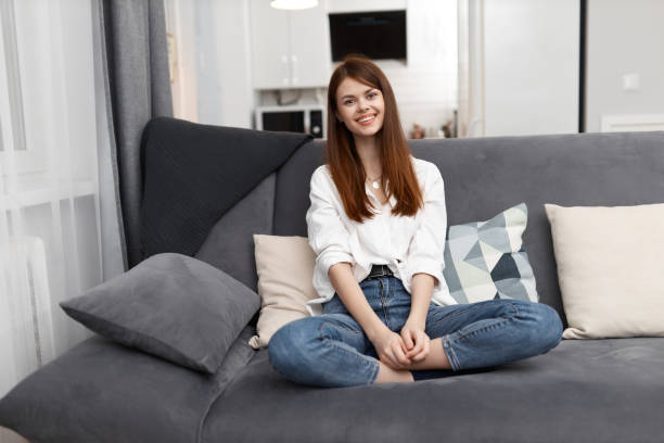 istock smiling woman sitting on a comfortable sofa in an apartment weekend 2187183914