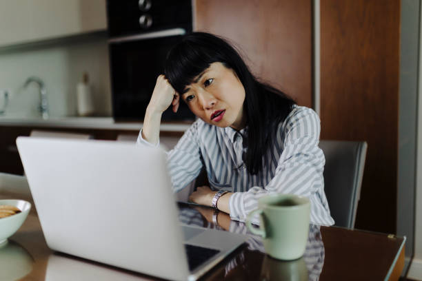 istock Tired businesswoman working on laptop 2187183986