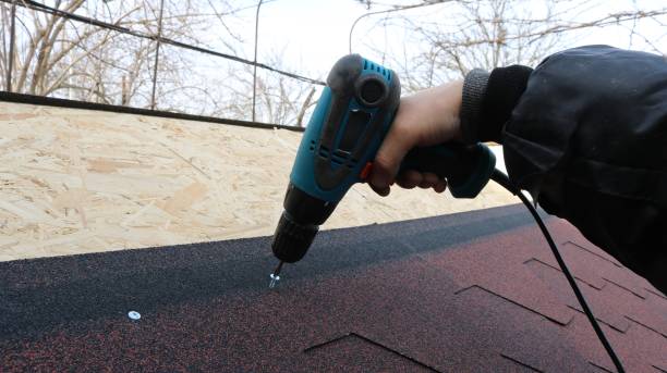 istock a screwdriver in hand fastens screws to the roof 2187185889