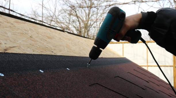 screwing screws into the roof structure with soft tiles