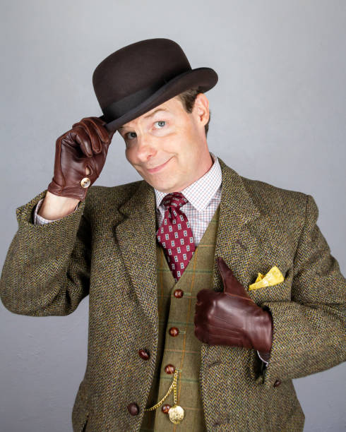 Man in seventies style suit get mesmerized by looking at pocket watch.speckled background is used especialy for hypnosis concept.The shot is my self portrait